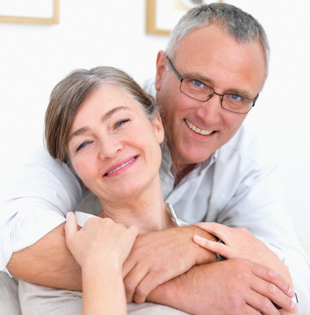 Closeup portrait of a smiling old couple at home